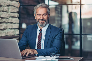 Man in suit sitting at computer